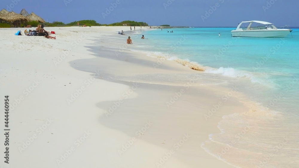Klein Curacao, Curacao - June 2021: The usually lively beach a popular day trip destination, lies with few visitors enjoying the white sand beach as the tourist industry slowly recovers Klein Curacao, Curacao - June 2021: The usually lively beach a popular day trip destination, lies with few visitors enjoying the white sand beach as the tourist industry slowly recovers
