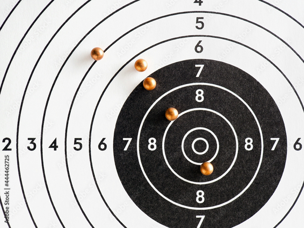 Balls or bullets for pneumatic shooting lie on a paper target. An illustration about shooting from an air gun. Top-down Balls or bullets for pneumatic shooting lie on a paper target. An illustration about shooting from an air gun. Top-down