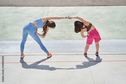 Girls training at fresh air at morning with concentrated emotions while making slopes