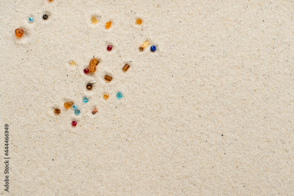 Stars falling. amber and beads on white sand background. Stars falling. amber and beads on white sand background.