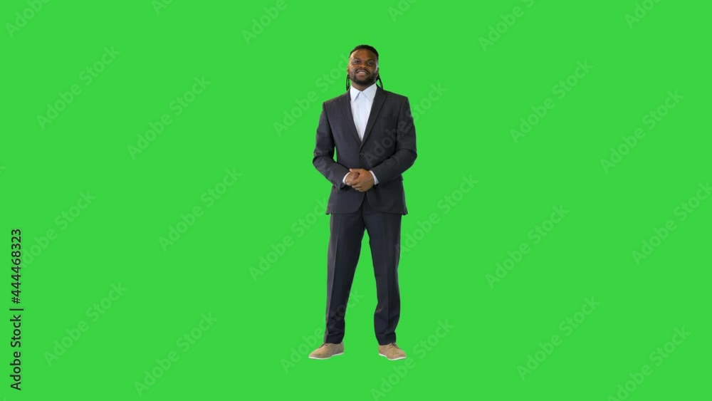 Black man in office suit telling something in front of camera on a Green Screen, Chroma Key. Black man in office suit telling something in front of camera on a Green Screen, Chroma Key.