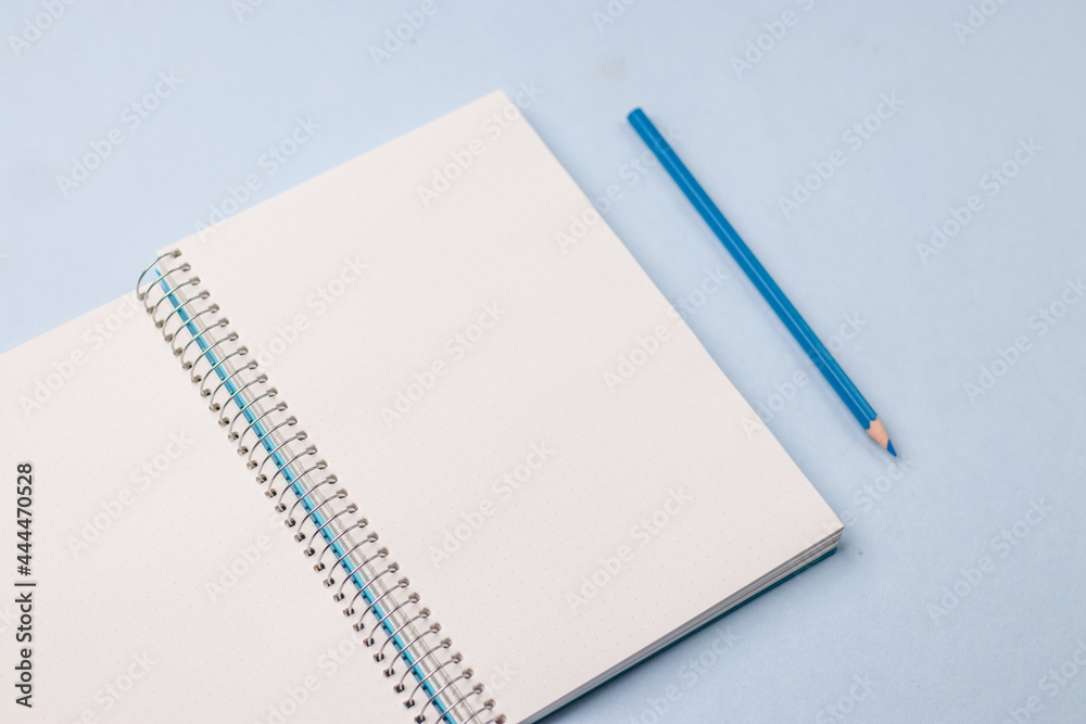 Empty notebook ready for mockup on blue table, top view, flatlay. Empty notebook ready for mockup on blue table, top view, flatlay.