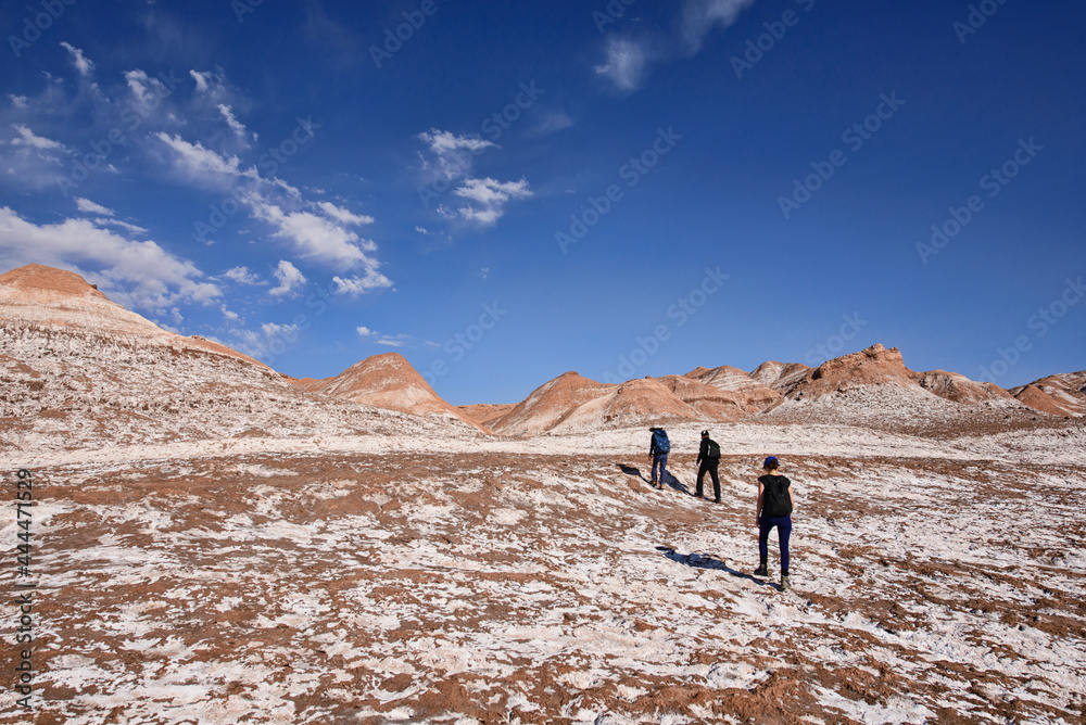 Trekking through the desert landscape in the Moon Valley, San Pedro de Atacama, Chile