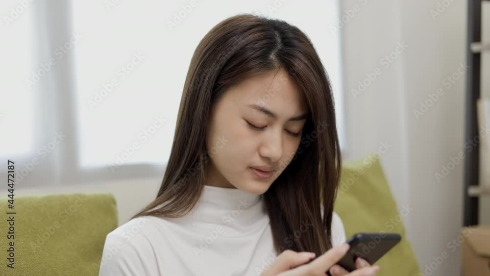 Unhappy teenage girl look at screen smartphone. She shopping online didn't buy it in time. Feeling stressed and depressed. Young asian woman has a problem with payment Unhappy teenage girl look at screen smartphone. She shopping online didn't buy it in time. Feeling stressed and depressed. Young asian woman has a problem with payment