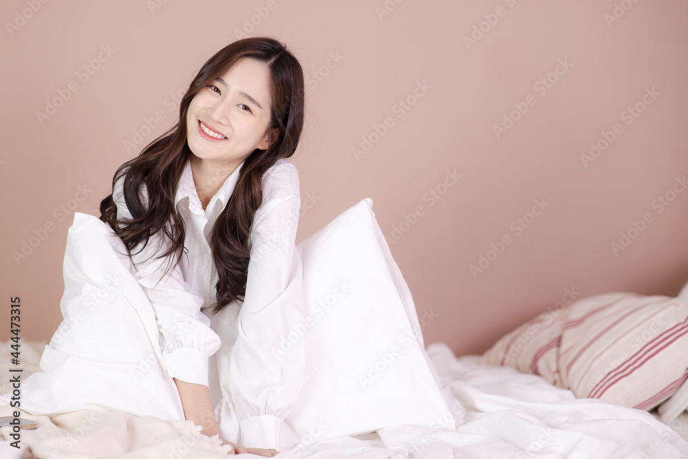 Cute woman sitting on her sofa with pillow in hands Cute woman sitting on her sofa with pillow in hands
