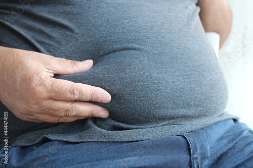 obese senior man touch his belly fat ,obesity