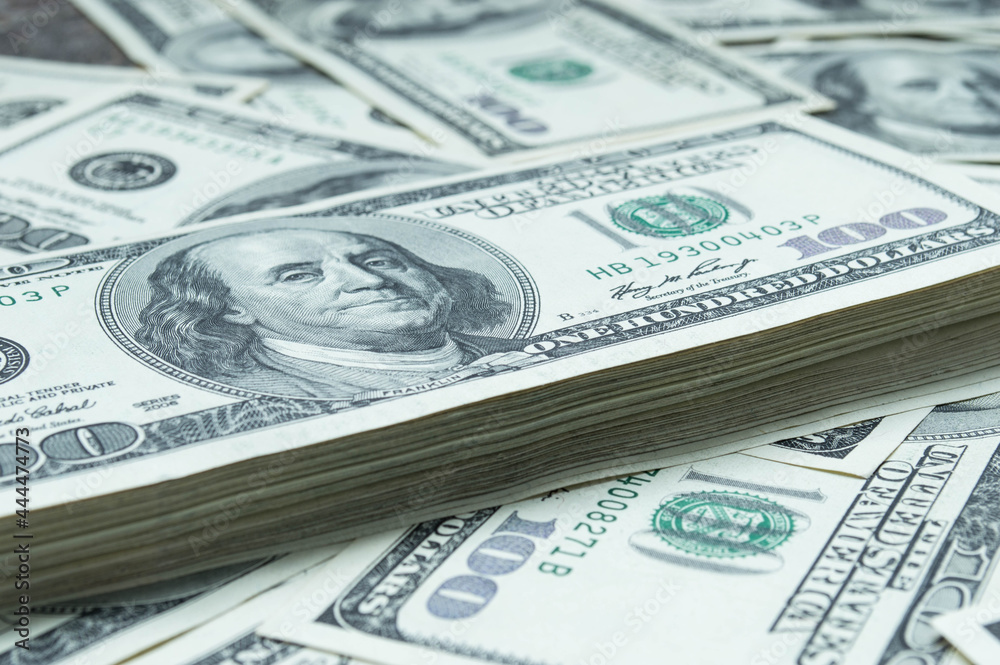 One hundred US dollars banknotes. Cash one hundred dollar bills, 100 dollars, Benjamin Franklin portrait, american currency exchange finance. Pile of hundred US dollars One hundred US dollars banknotes. Cash one hundred dollar bills, 100 dollars, Benjamin Franklin portrait, american currency exchange finance. Pile of hundred US dollars