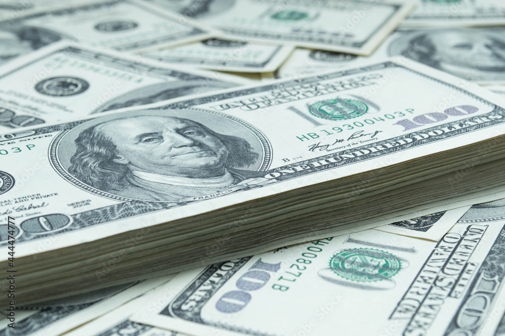 One hundred US dollars banknotes. Cash one hundred dollar bills, 100 dollars, Benjamin Franklin portrait, american currency exchange finance. Pile of hundred US dollars One hundred US dollars banknotes. Cash one hundred dollar bills, 100 dollars, Benjamin Franklin portrait, american currency exchange finance. Pile of hundred US dollars