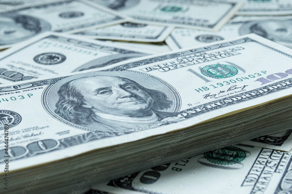 One hundred US dollars banknotes. Cash one hundred dollar bills, 100 dollars, Benjamin Franklin portrait, american currency exchange finance. Pile of hundred US dollars One hundred US dollars banknotes. Cash one hundred dollar bills, 100 dollars, Benjamin Franklin portrait, american currency exchange finance. Pile of hundred US dollars