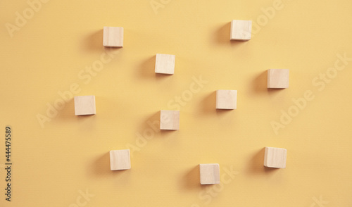 Wooden cubes on yellow background.