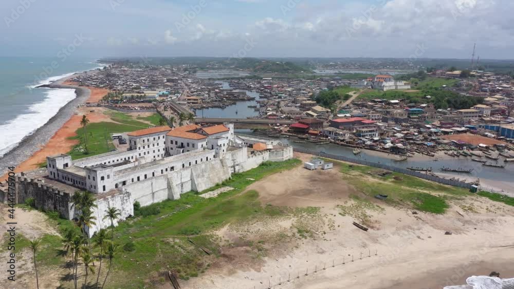 Aerial Elmina Castle fishing village Ghana Africa fast motion. Ghana West Africa on the Atlantic ocean. 500 years it was owned by the Dutch and British major slave castle in Africa. Aerial Elmina Castle fishing village Ghana Africa fast motion. Ghana West Africa on the Atlantic ocean. 500 years it was owned by the Dutch and British major slave castle in Africa.