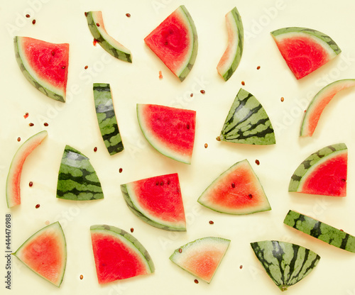 Fototapeta Naklejka Na Ścianę i Meble -  Small watermelon on a sunny yellow pastel pattern background. Trendy summer fruits and refreshments. Minimal summer food concept.