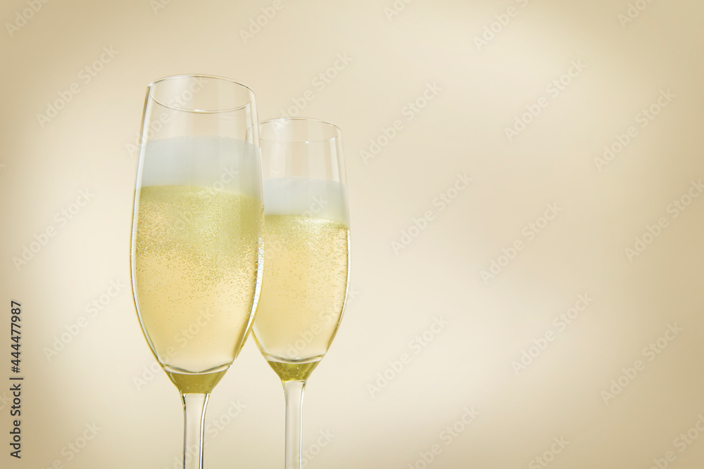 Champagne glasses. The second glass is a little bit blurred.