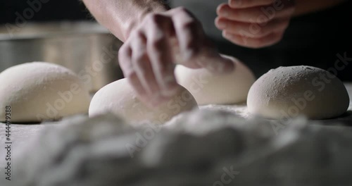 Close up shot of bakery worker carefuly forming loafs of bread. Baker making dough, using natural ingredients. food and drink 4k footage photo
