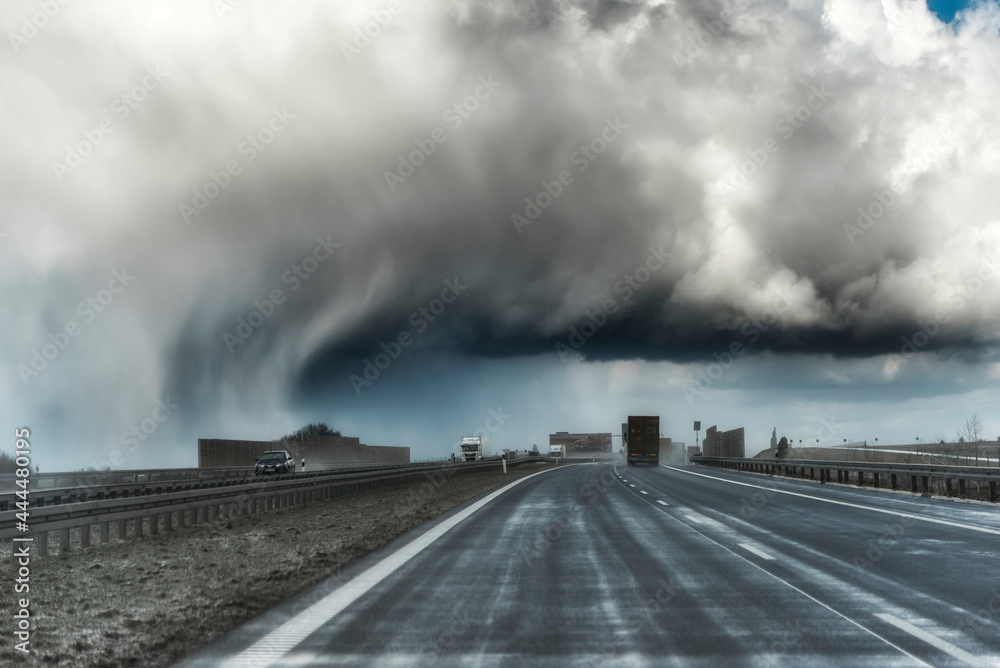 Dramatic view of a shelf cloud over a highway, horizontal cloud formation, panorama view.