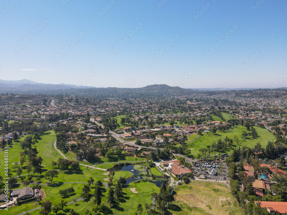 Aerial view of residential neighborhood surrounded by golf and valley during sunny day in Rancho Bernardo, San Diego County, California. USA. 