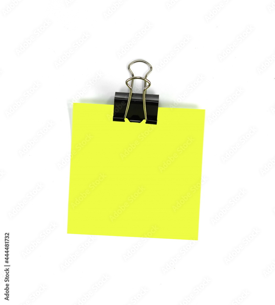Close-up shot of paperclip on blank yellow note. Close-up shot of paperclip on blank yellow note.