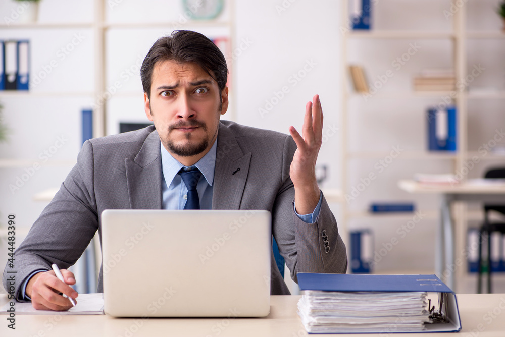 Young male employee working in the office Young male employee working in the office