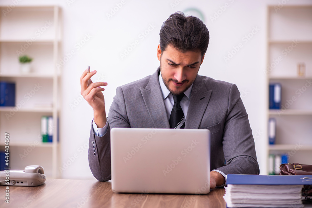 Young businessman employee working in the office Young businessman employee working in the office