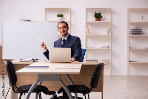 Young male employer in front of white board