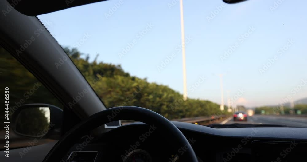 Driving car on highway, hands holding the steering wheel Driving car on highway, hands holding the steering wheel