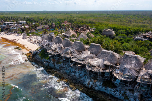 Tulum, Mexico. May 15, 2021. Aerial view of the luxury hotel Azulik in Tulum. Beautiful view of the eco wooden houses in the jungle by the sea shore.