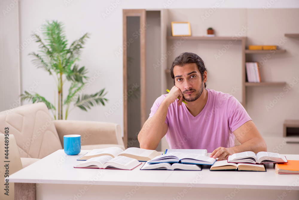 Young male student preparing for exams at home Young male student preparing for exams at home