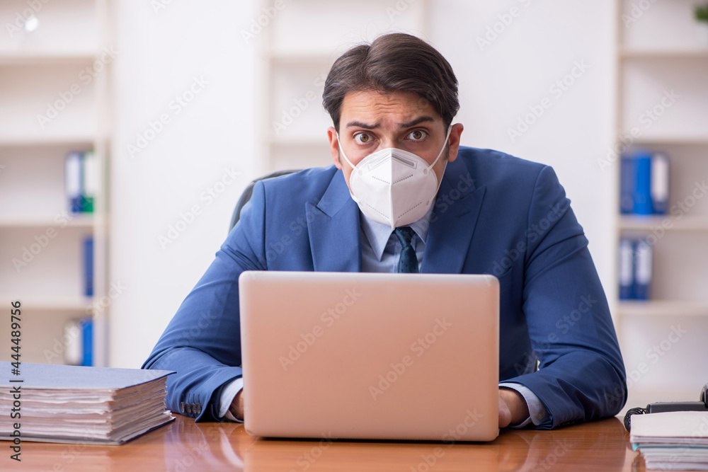 Young businessman employee working in the office during pandemic Young businessman employee working in the office during pandemic