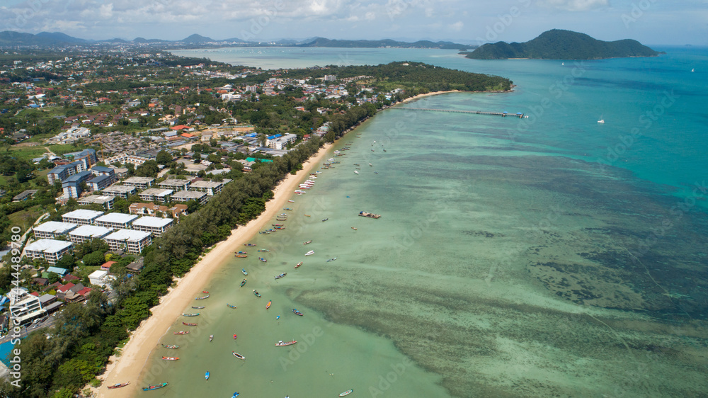 Aerial View of Thai traditional longtail fishing boats in the tropical sea beautiful beach in phuket thailand.