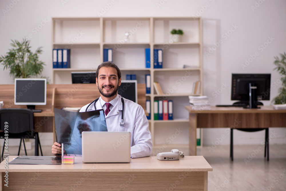 Young male doctor radiologist sitting in the office Young male doctor radiologist sitting in the office