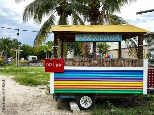 Rainbow colored food cart stand serving Mexican food. Empty photo