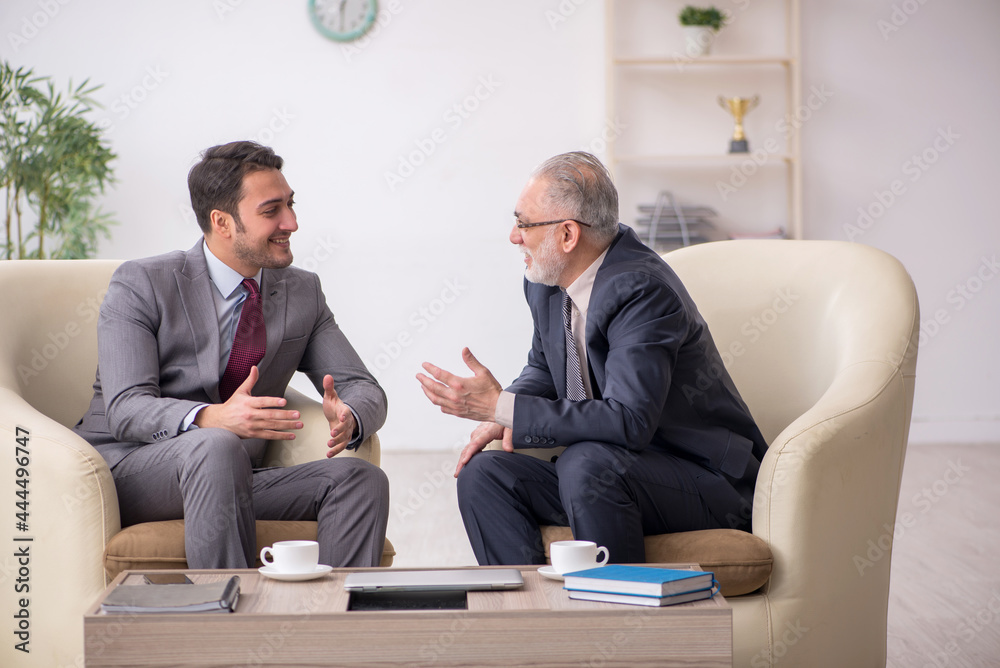 Two businessmen discussing project at workplace