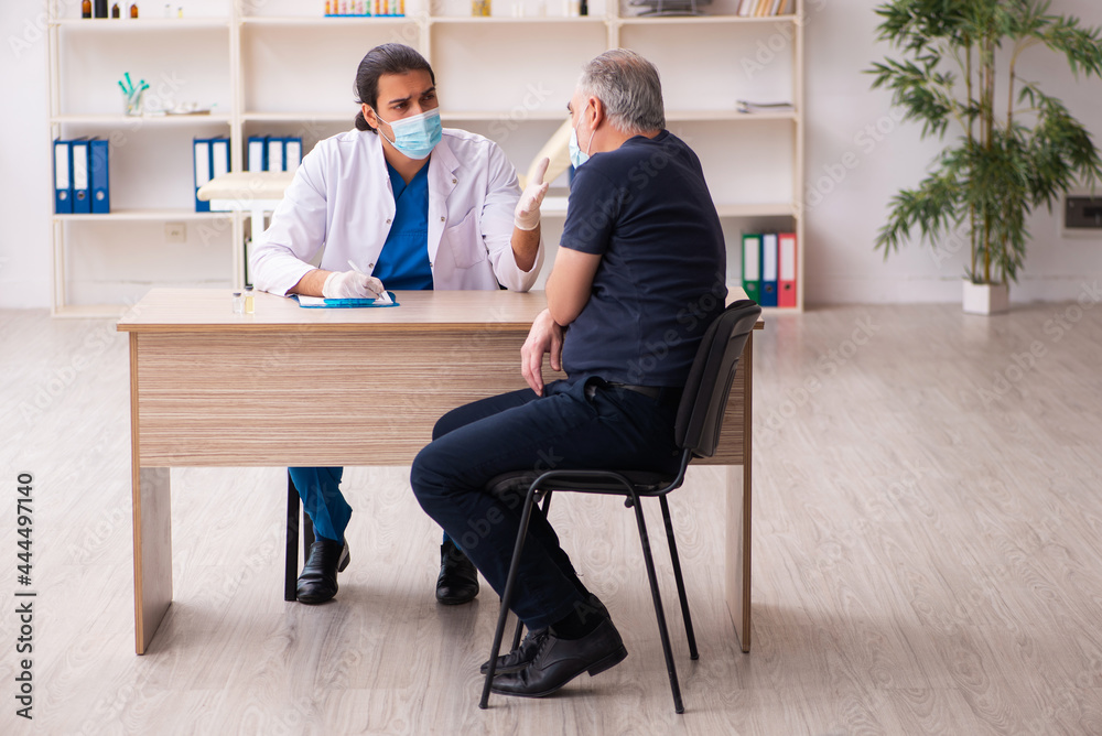 Old man visiting young doctor in covid-19 vaccination concept Old man visiting young doctor in covid-19 vaccination concept