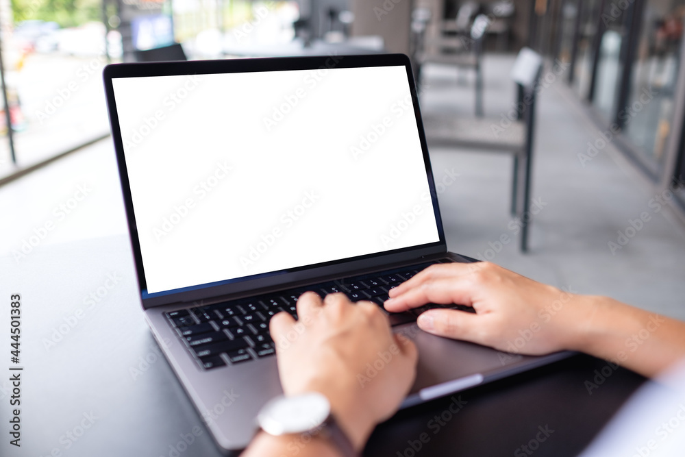 Mockup image of a woman using and typing on laptop computer with blank white desktop screen in cafe Mockup image of a woman using and typing on laptop computer with blank white desktop screen in cafe