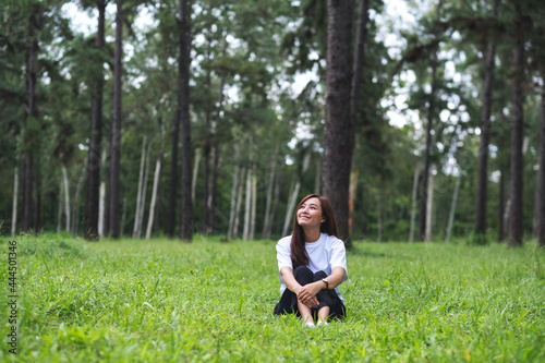 Portrait image of a beautiful asian woman sitting and relaxing in the park