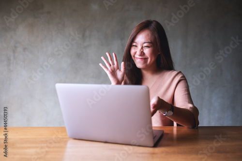 A beautiful young asian woman using laptop computer for video call and working online at home © Farknot Architect