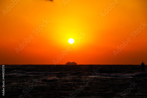 Cruise ship sailing at sunset