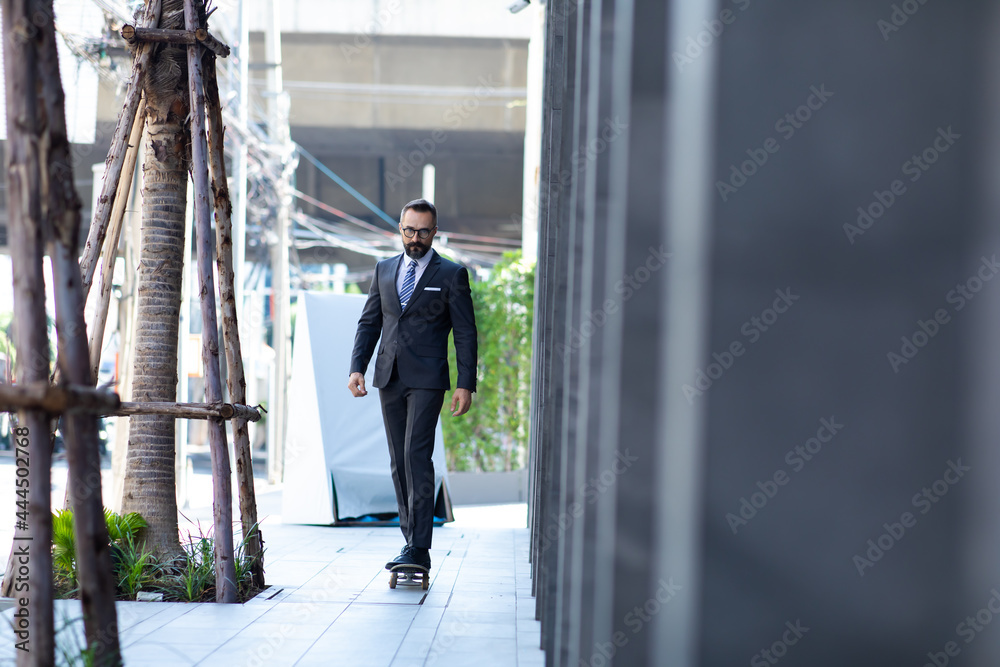 Stylish hipster bearded man skater riding a longboard go to working at the city.