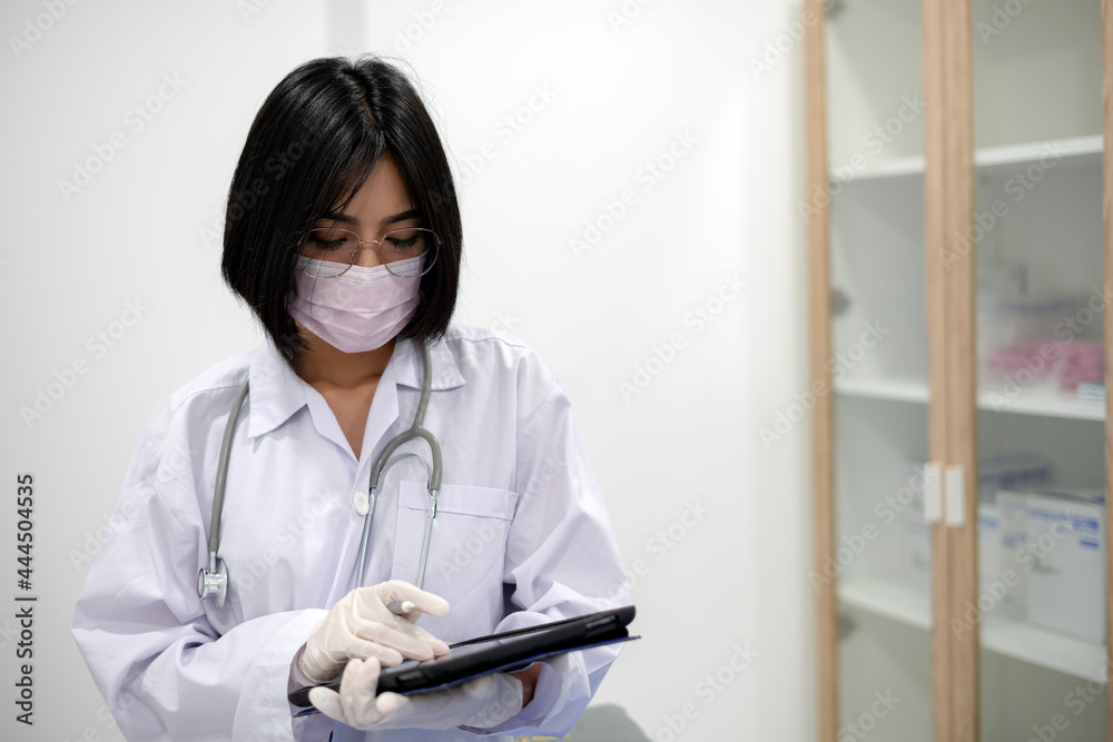 young Asian Female woman Doctor With Stethoscope On Her Neck And Clipbroad In Her Hands,Doctor Stand in office young Asian Female woman Doctor With Stethoscope On Her Neck And Clipbroad In Her Hands,Doctor Stand in office