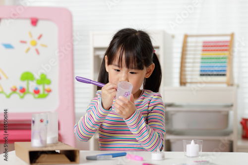 youngi girl decorating tea light set for homeschooling photo