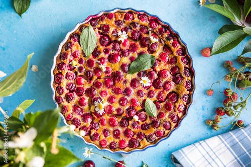 cherry Clafoutis with cherry on a blue  background photo