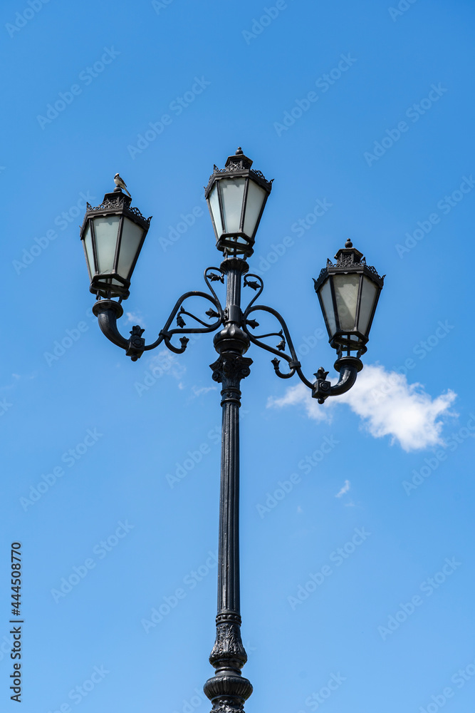 City lantern on a background of blue sky