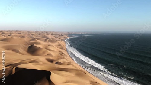 Aerial view of Sandwich Harbour, where towering sand dunes meet the Atlantic coast, near Walvis Bay in the Namib-Naukluft National Park, Namibia, Africa. photo