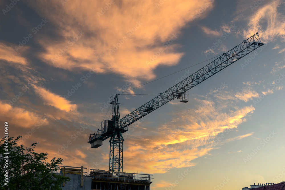 Construction crane on the sunset background Construction crane on the sunset background