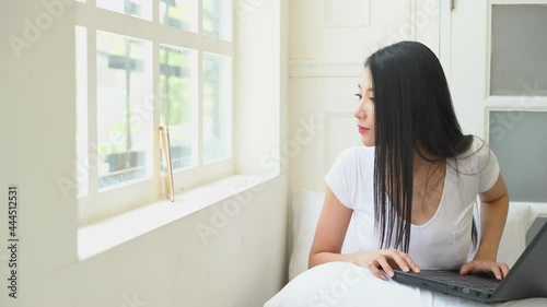 woman wearing white t-shirt using cellphone at home