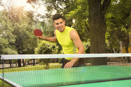 Man playing ping pong in park on summer day © New Africa