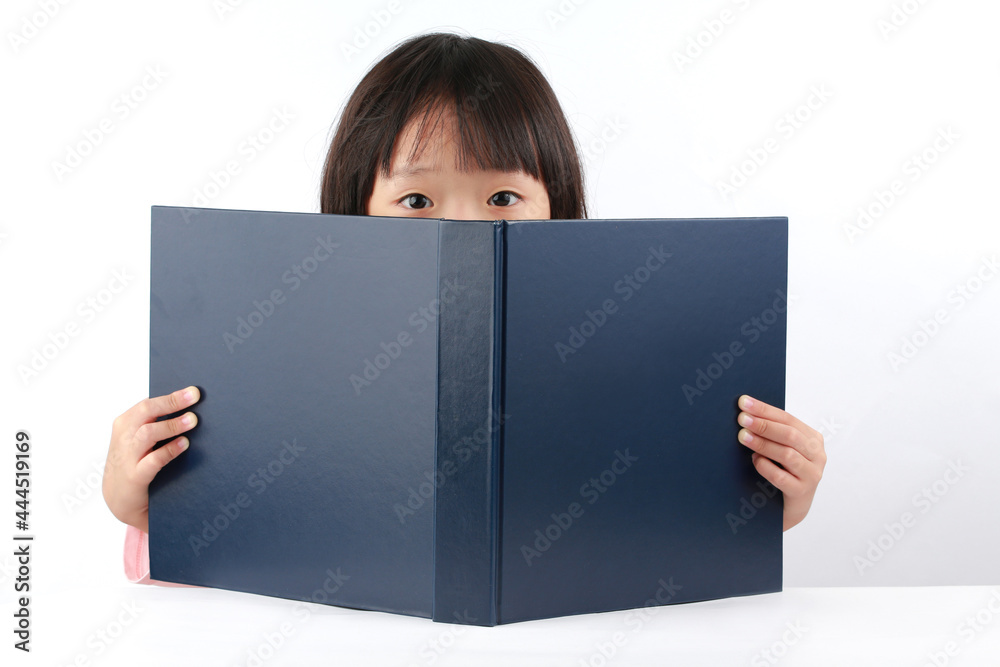 Picture of a cute schoolgirl peeping out of a book Picture of a cute schoolgirl peeping out of a book