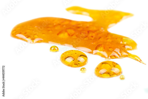 golden drops cannabis wax close up macro on white background