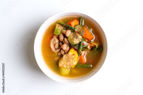 Sayur asam close up in white bowl over white background.