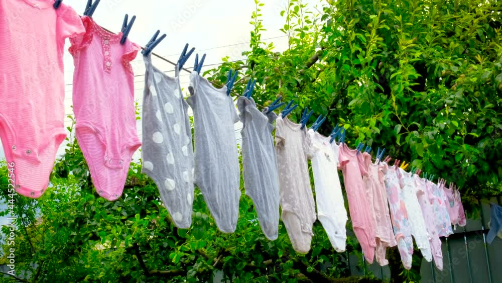 Baby clothes are dried outside. Selective focus.